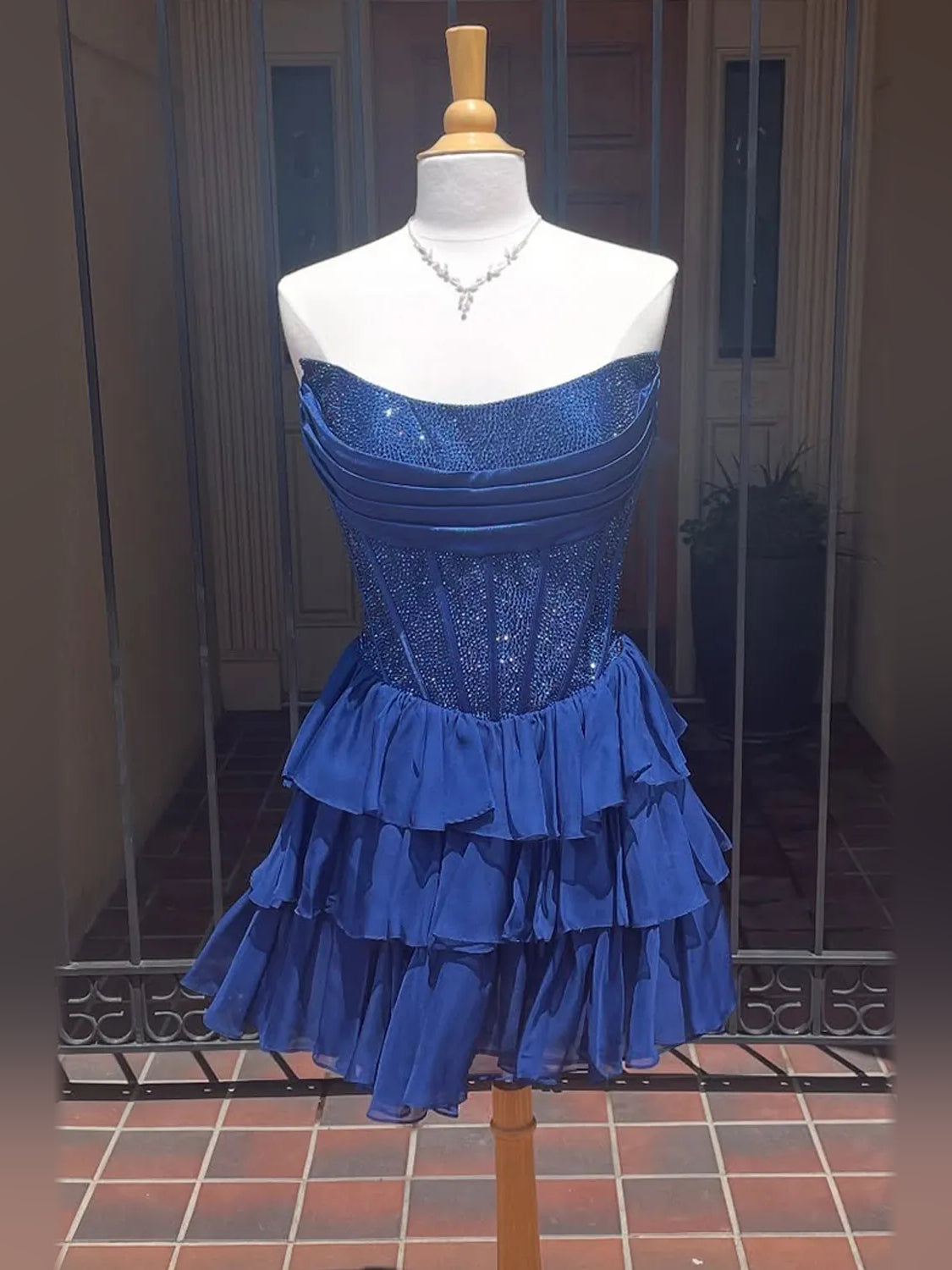Navy strapless chiffon homecoming dress with glitter bodice and layered ruffle skirt
