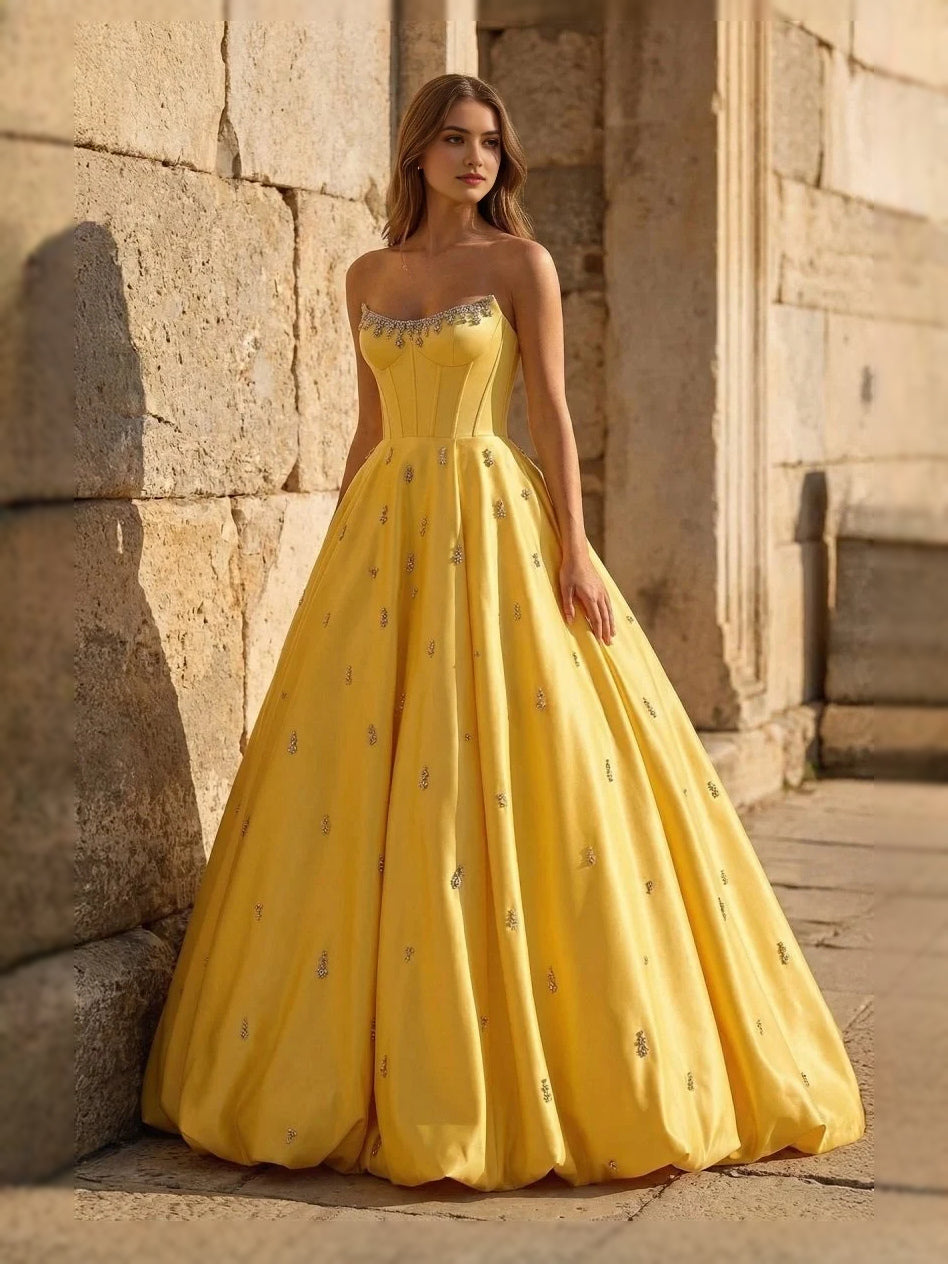 Yellow sweetheart corset ball gown with thin straps and full floor-length skirt, front view