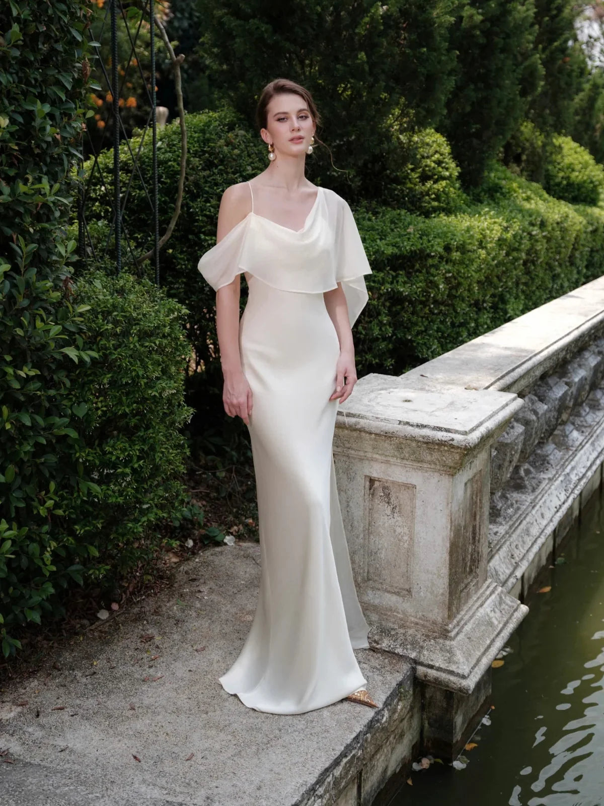 Ivory off-shoulder satin mermaid wedding dress with draped sleeve overlay
