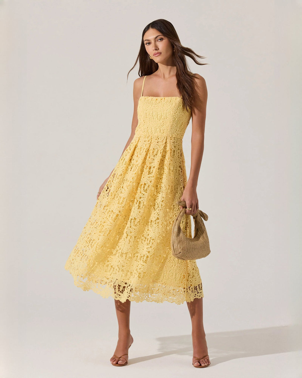 Yellow sleeveless A-line midi dress with spaghetti straps and lace-textured skirt