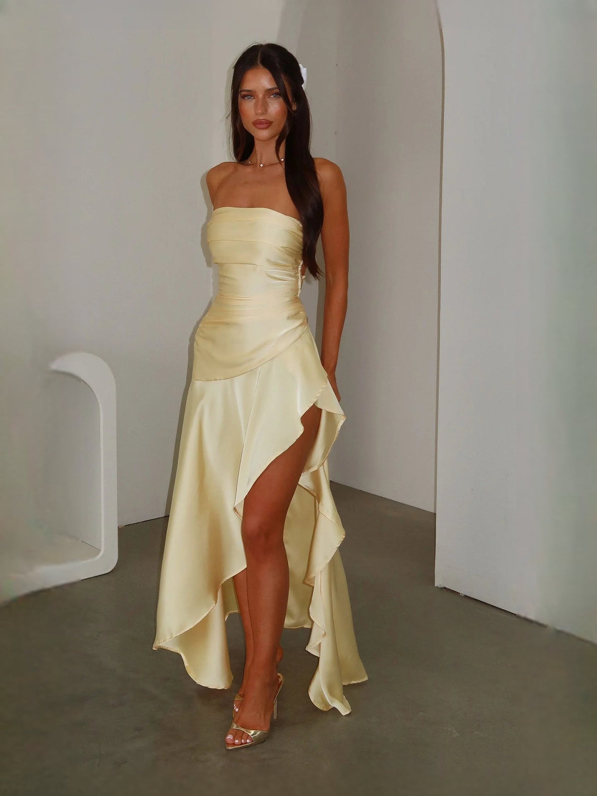 Strapless ruched satin prom dress in pale yellow with ruffled side slit, A-line