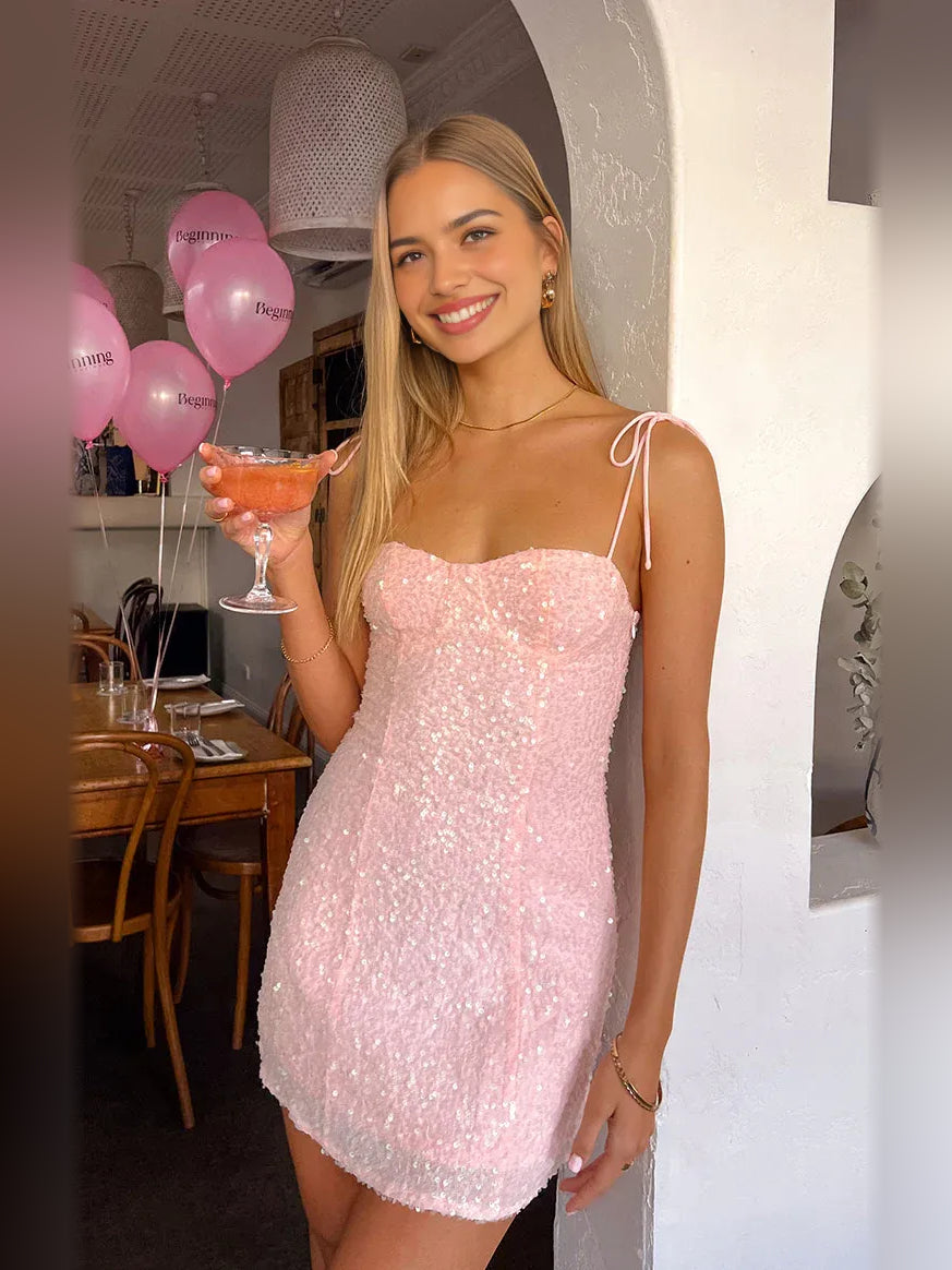 Light pink sequin sweetheart mini dress with thin straps and bow-tie back detail