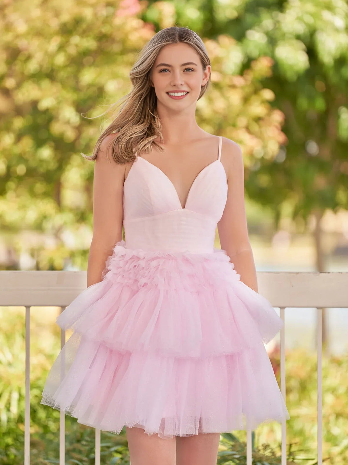 Blush pink mini tulle dress with V-neck, spaghetti straps, voluminous layered ruffle skirt