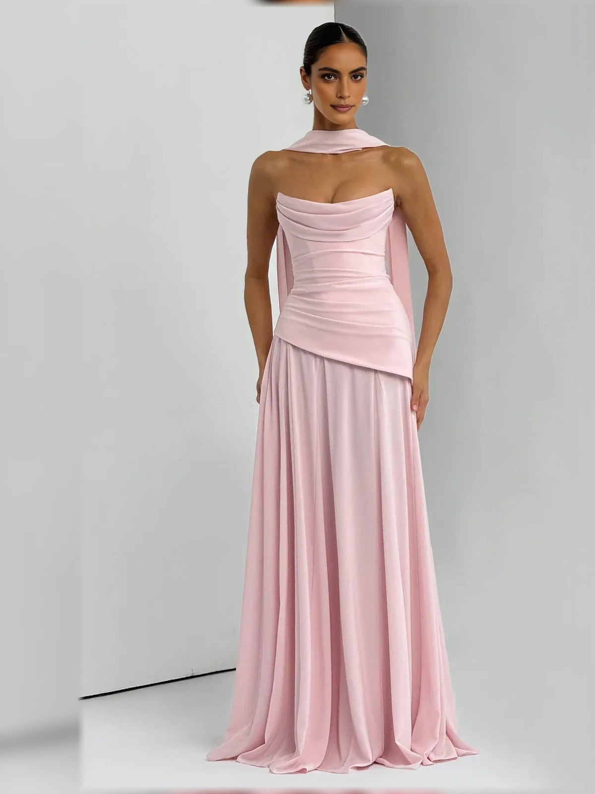 Blush pink strapless corset formal dress with draped bodice and pleated floor skirt