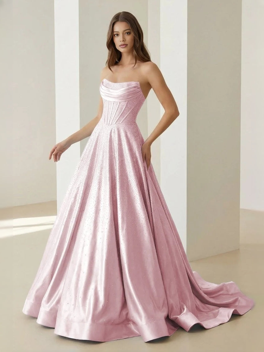 Blush pink strapless draped corset ball gown with full floor-length skirt