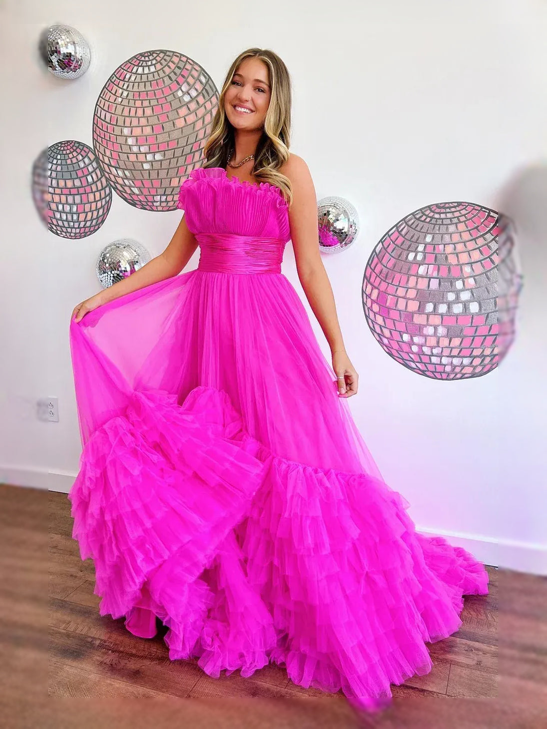 Hot pink strapless sweetheart A-line tulle prom dress with ruched bodice and layered ruffle skirt