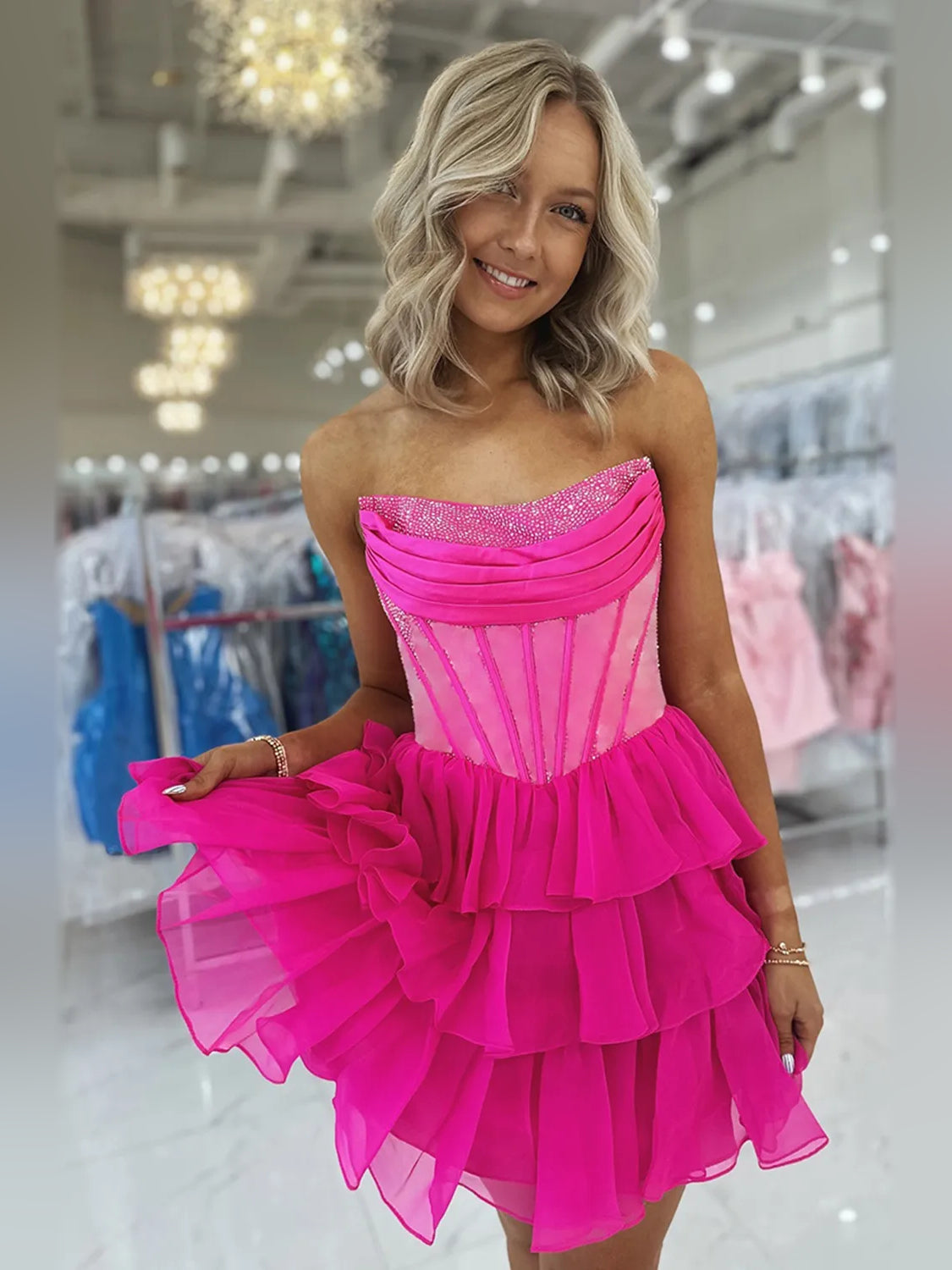 Hot pink strapless chiffon homecoming dress with glittery bodice and layered ruffle skirt