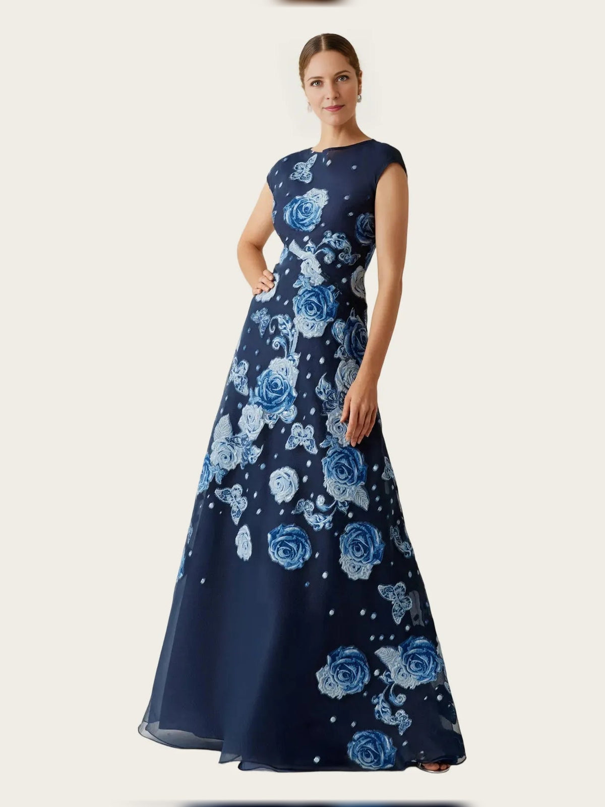 Front view: navy A-line maxi dress with round neck, cap sleeves, and blue rose floral print
