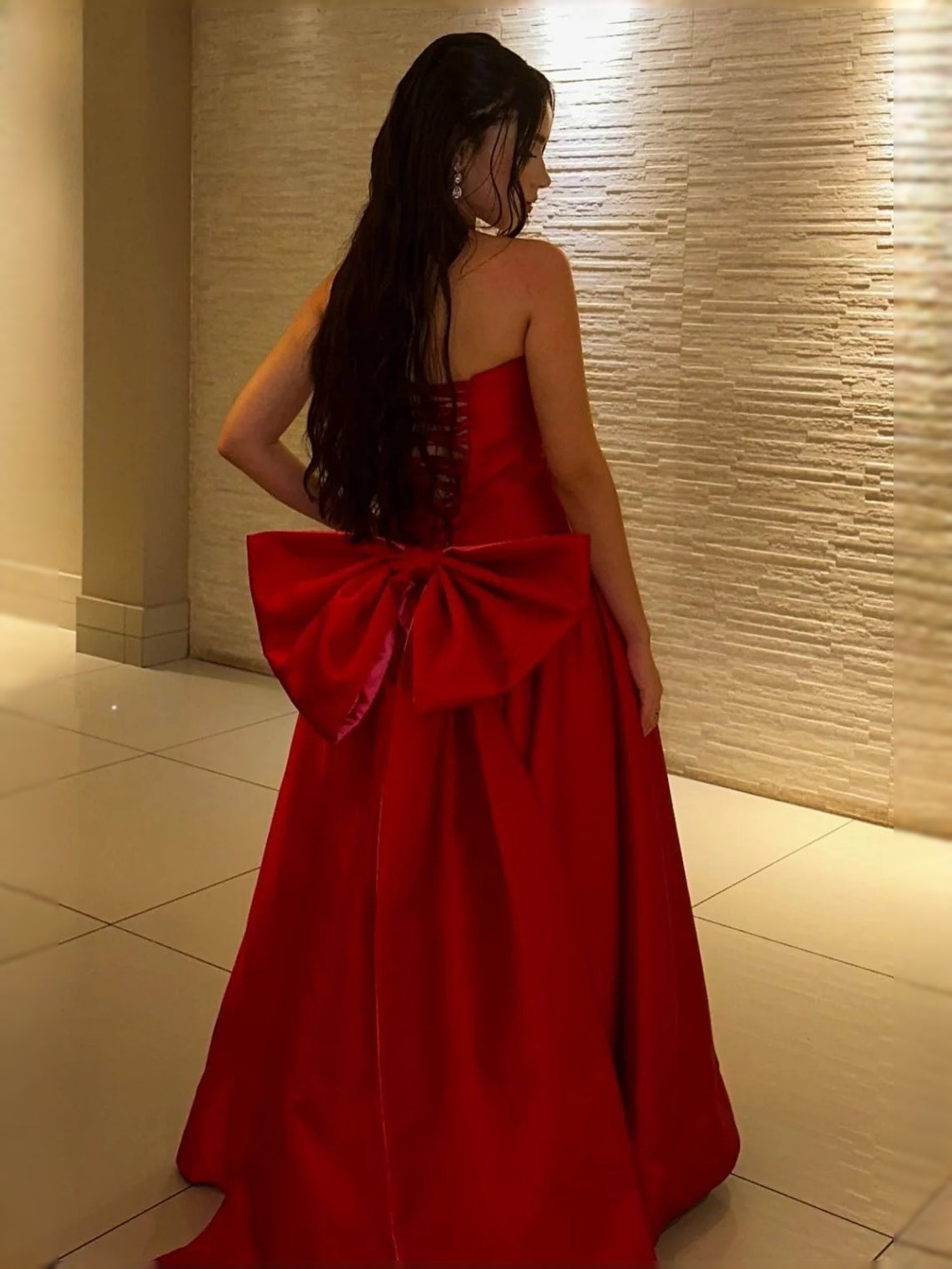 Red corset mini dress with oversized bow detail at the back, flowing A-line skirt