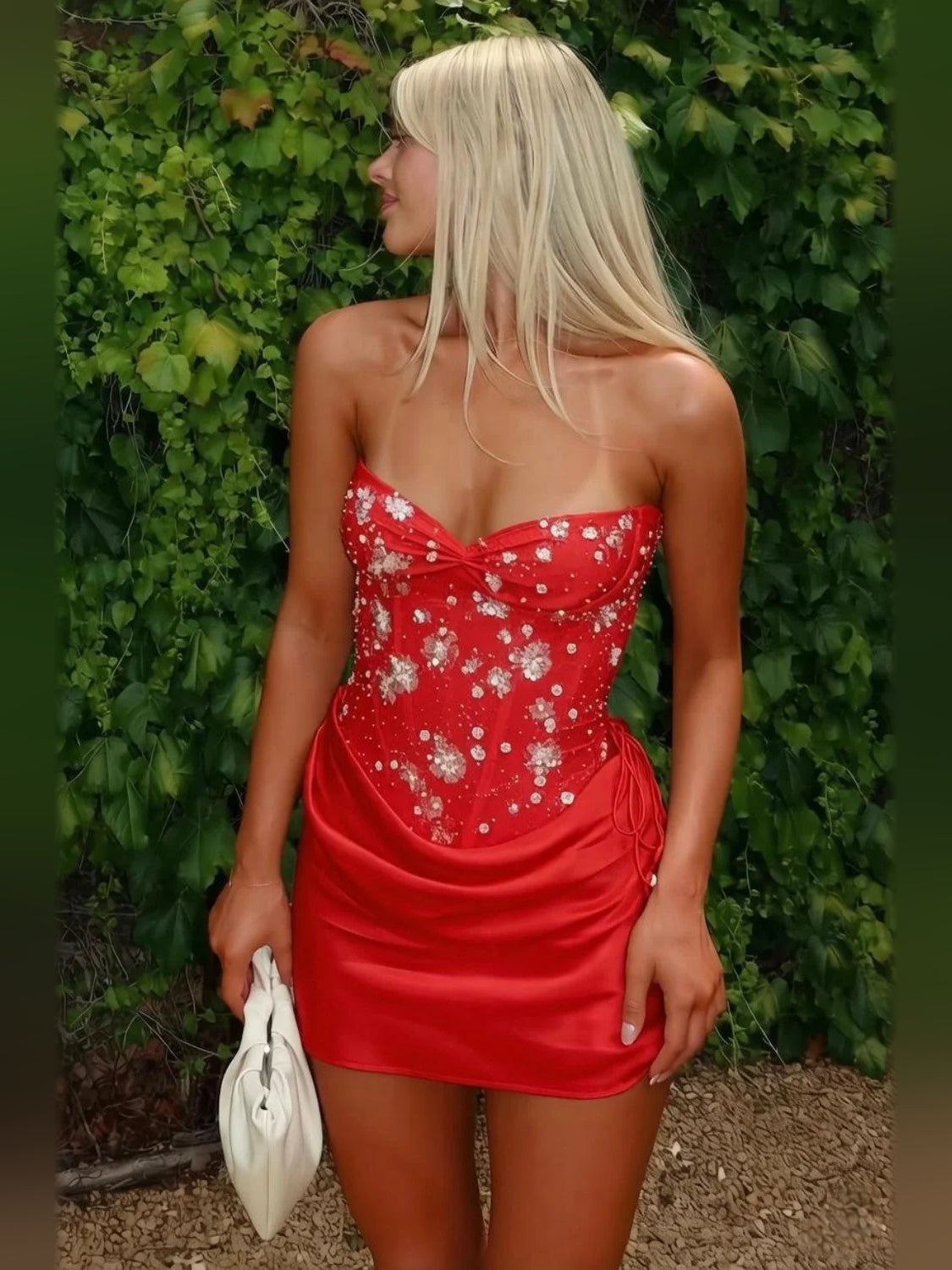 Red satin mini dress with ruched draped sweetheart bodice and scattered sparkling floral beads