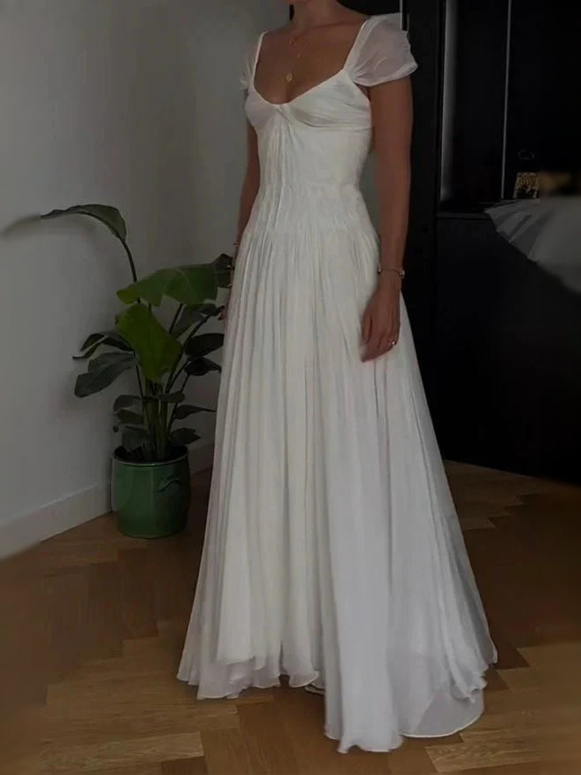 Ivory A-line wedding dress with sweetheart neckline and pleated skirt, side view