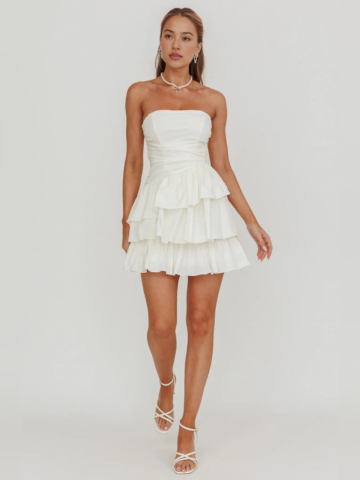 Ivory strapless A-line mini dress with ruched bodice and tiered ruffle skirt