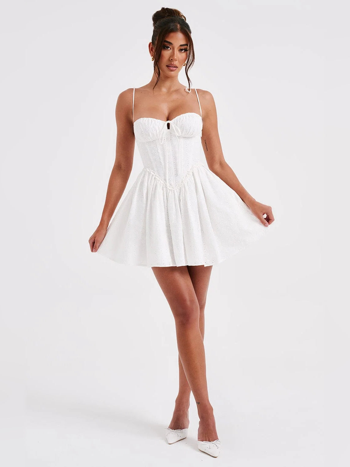 Ivory mini dress with sweetheart bodice, thin tie straps, and flared gathered skirt