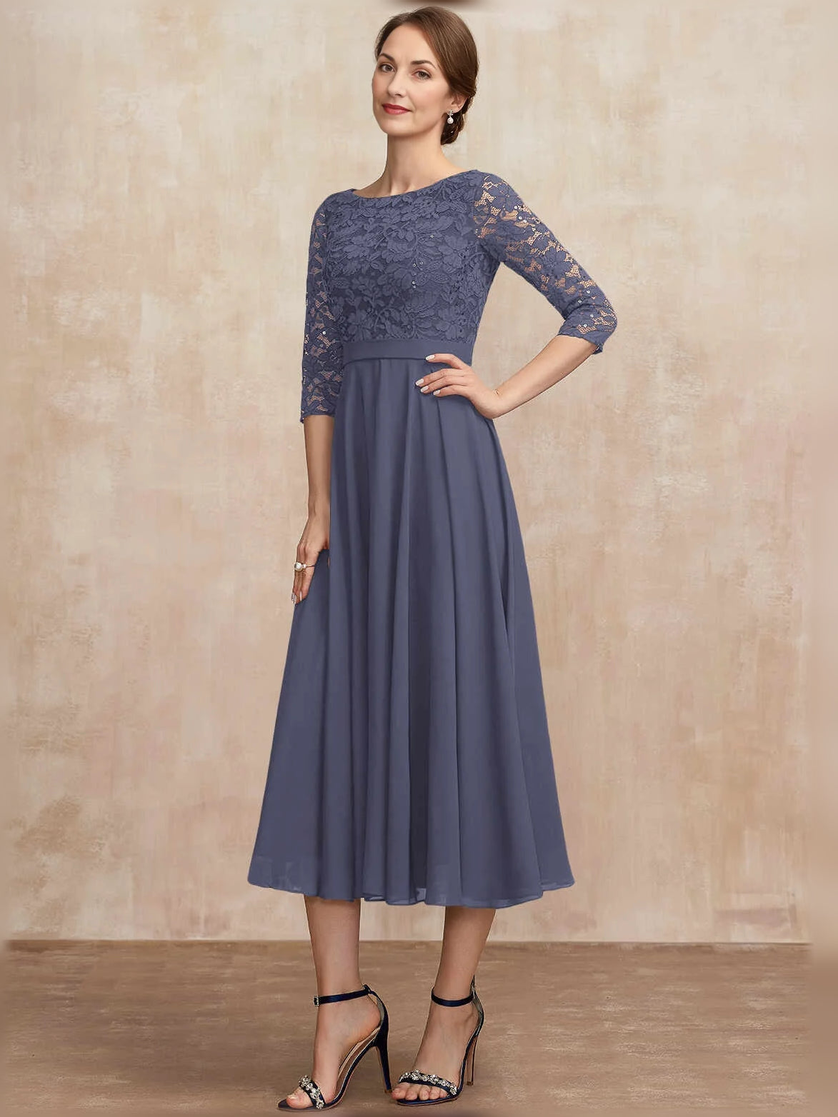 Dark blue pleated midi dress with bateau neckline, lace sleeves, and A-line chiffon skirt