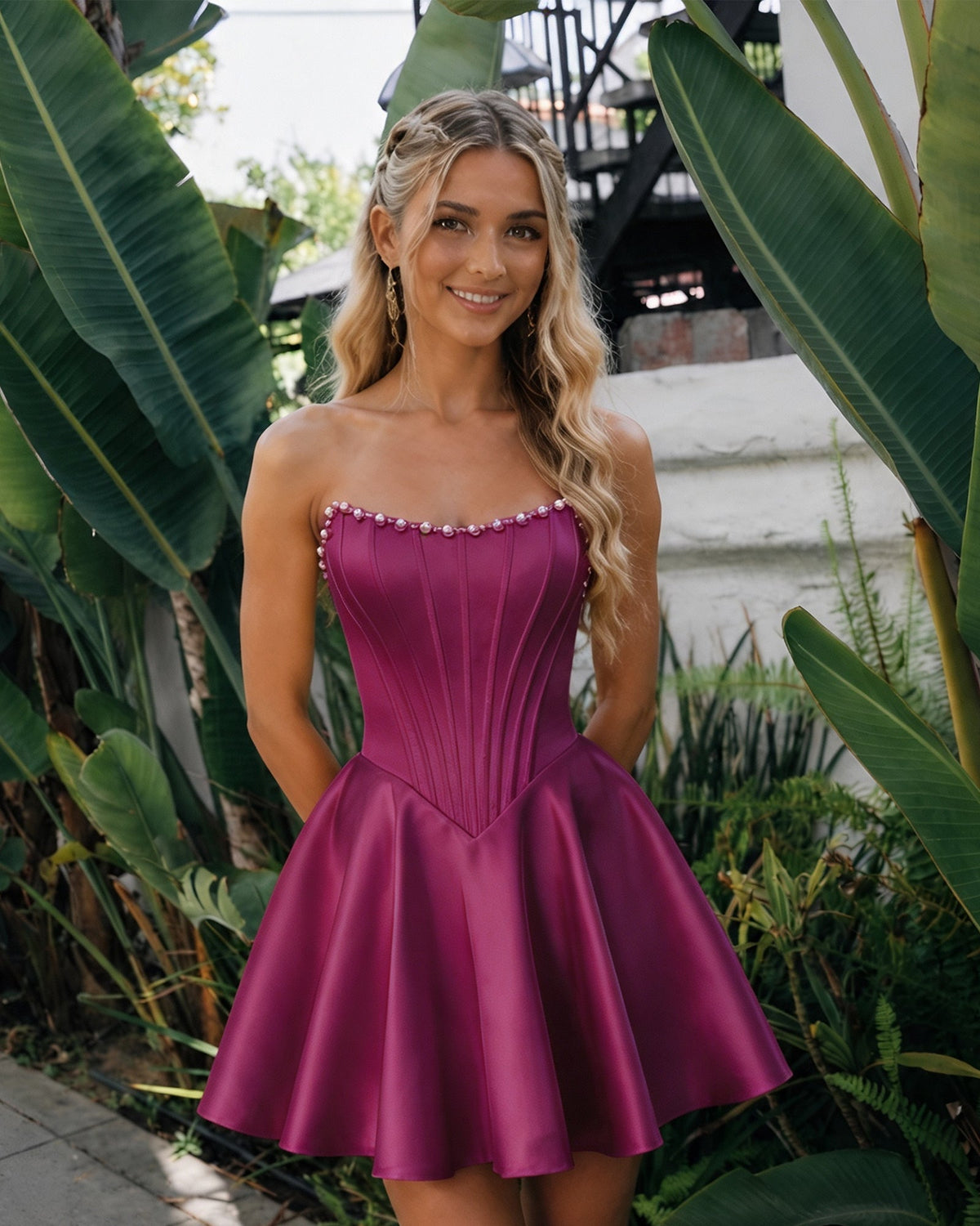 Front view of strapless satin homecoming dress with pearl trim and flared skirt—deep plum purple