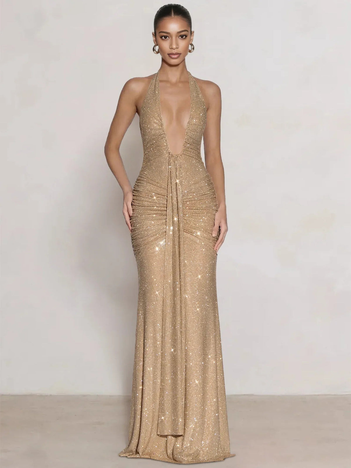 Front view of a gold halter neck ruching midi formal dress with sequins