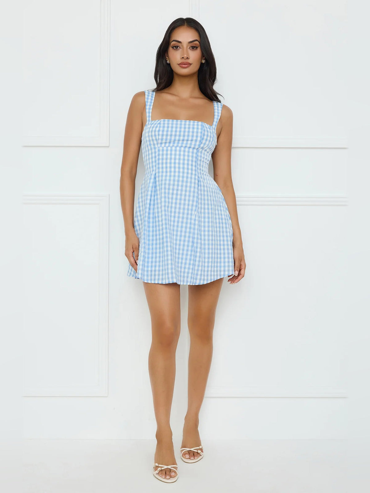 Light blue gingham mini dress with square neckline, thin straps, and flared skirt