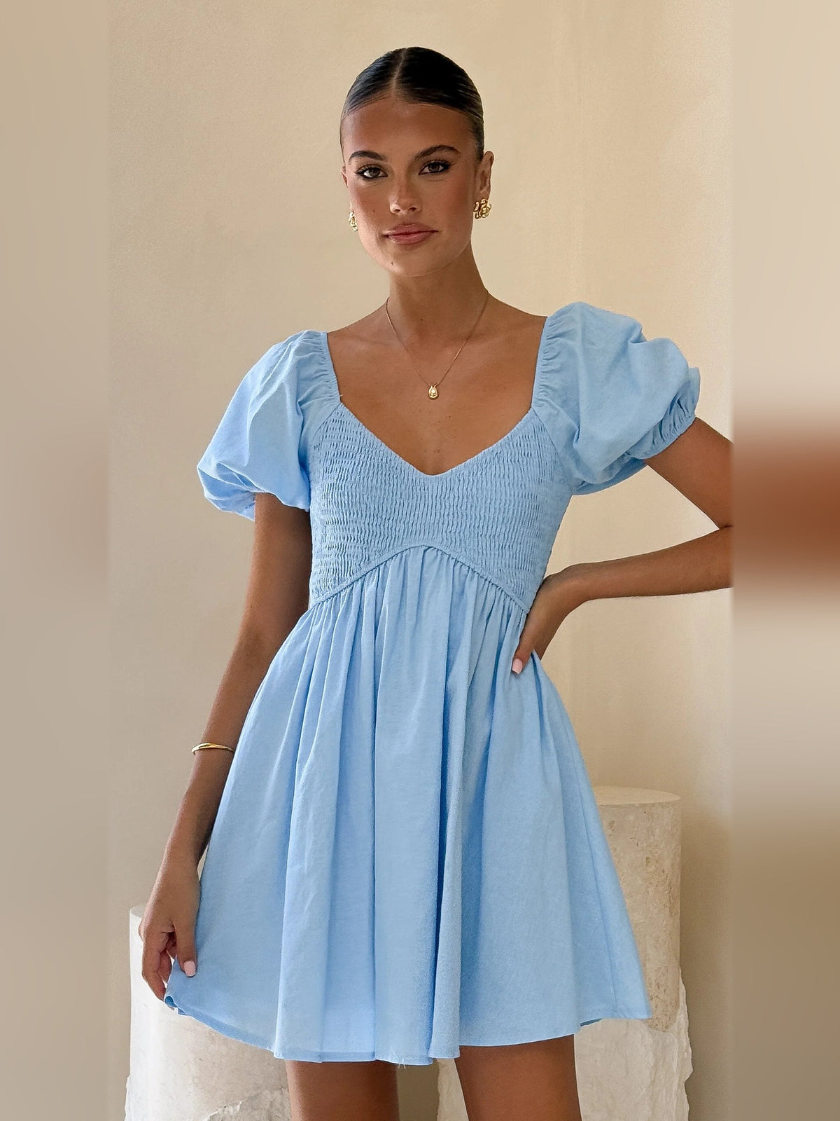 Light blue mini homecoming dress with V-neck and puff sleeves, gathered waist