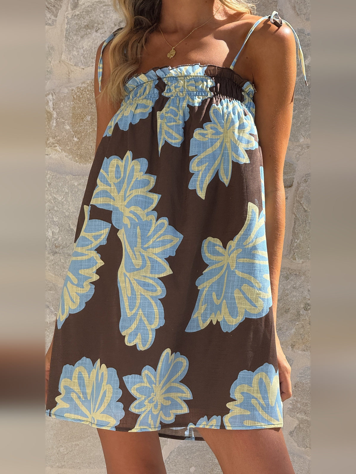 Brown floral mini dress front view, smocked bust and light blue flower print