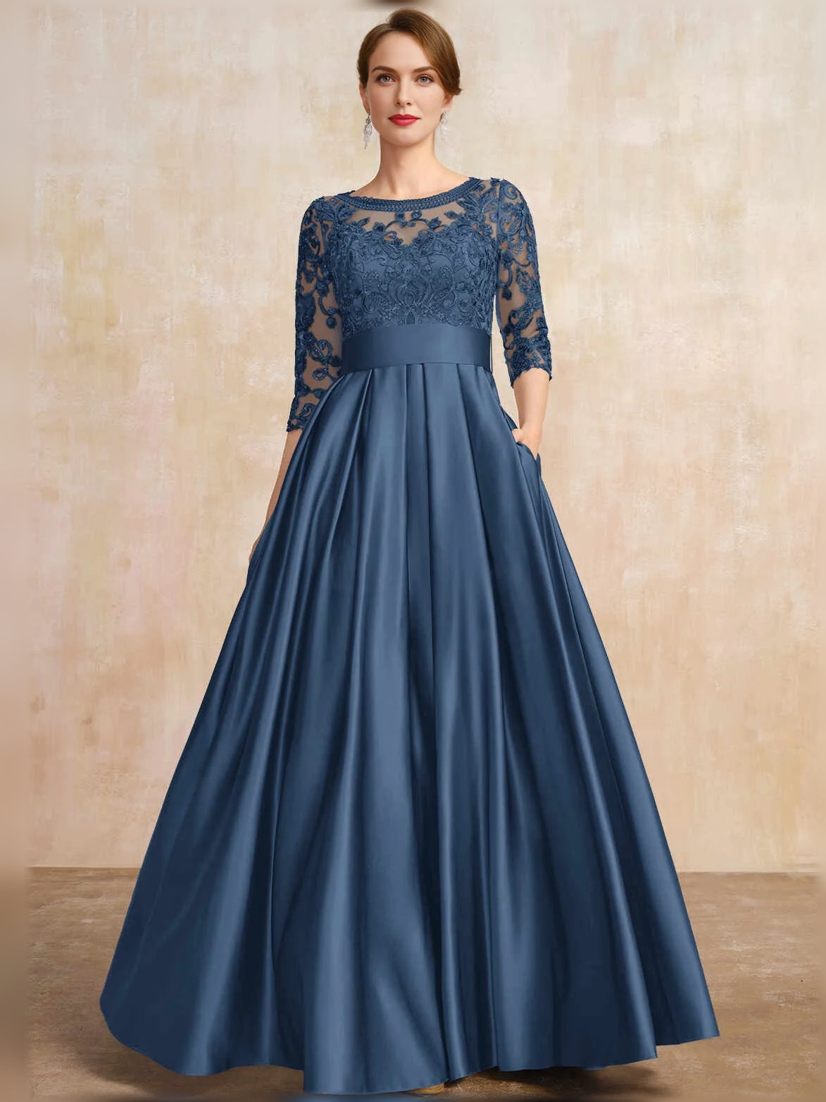 Dark blue satin A-line dress with lace overlay sleeves and pleated floor-length skirt