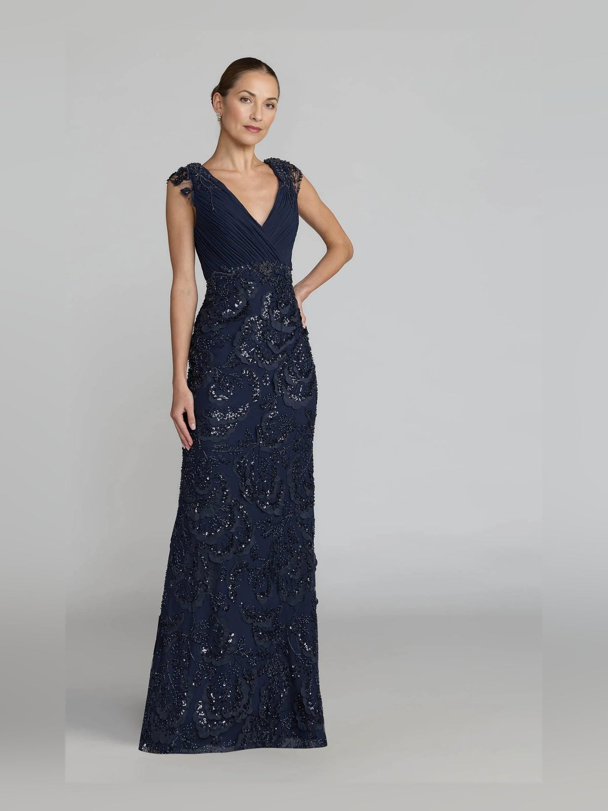Dark blue floor-length sleeveless V-neck sheath gown with scalloped floral beadwork