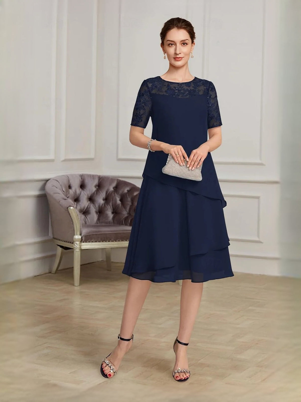 Navy blue lace-yoke chiffon midi dress with short sleeves and layered tiered A-line skirt.