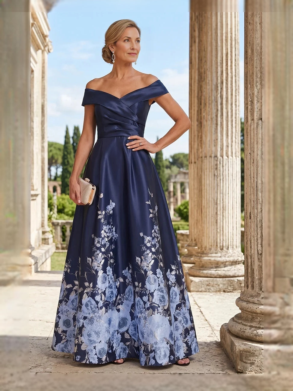 Off-shoulder satin A-line floor-length gown in navy with blue floral print skirt, standing pose