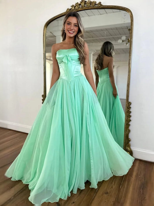 Mint green strapless corset prom dress with bow detail and gathered A-line hem