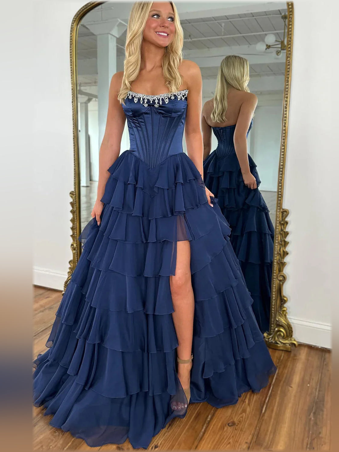 Dark navy floor-length strapless dress with tiered skirt ruffles and side slit