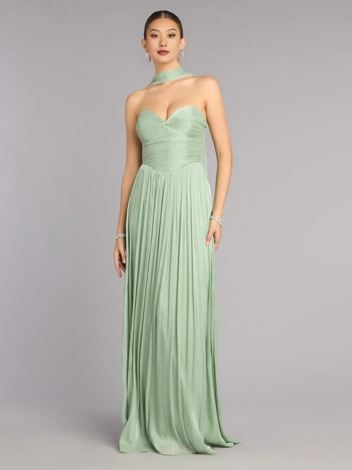 Sage green sweetheart A-line prom dress with ruched bodice and flowing pleated maxi skirt