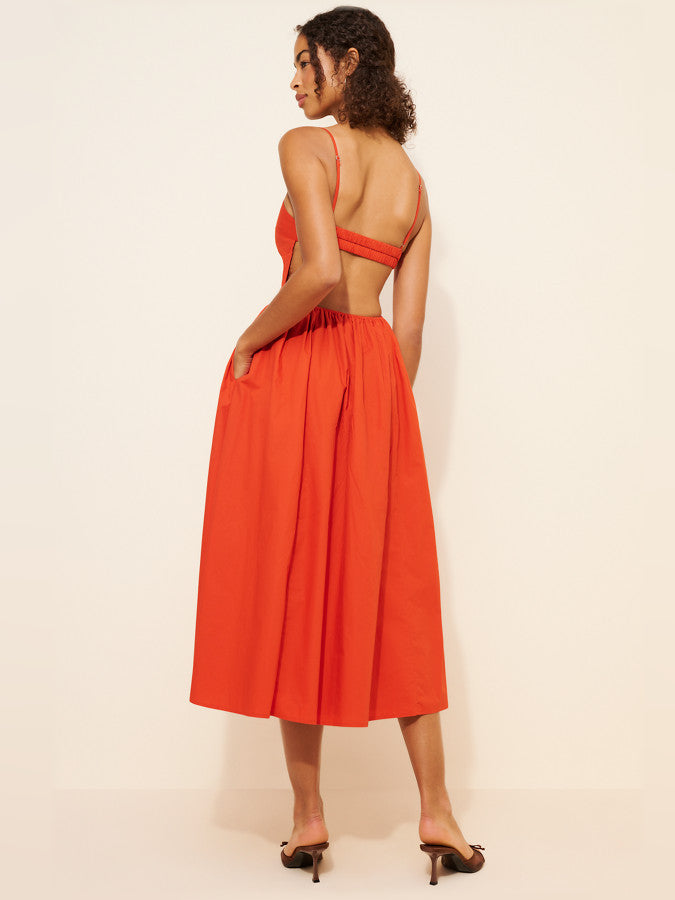 Coral red sleeveless midi dress with open back, ruched waist, and gathered skirt