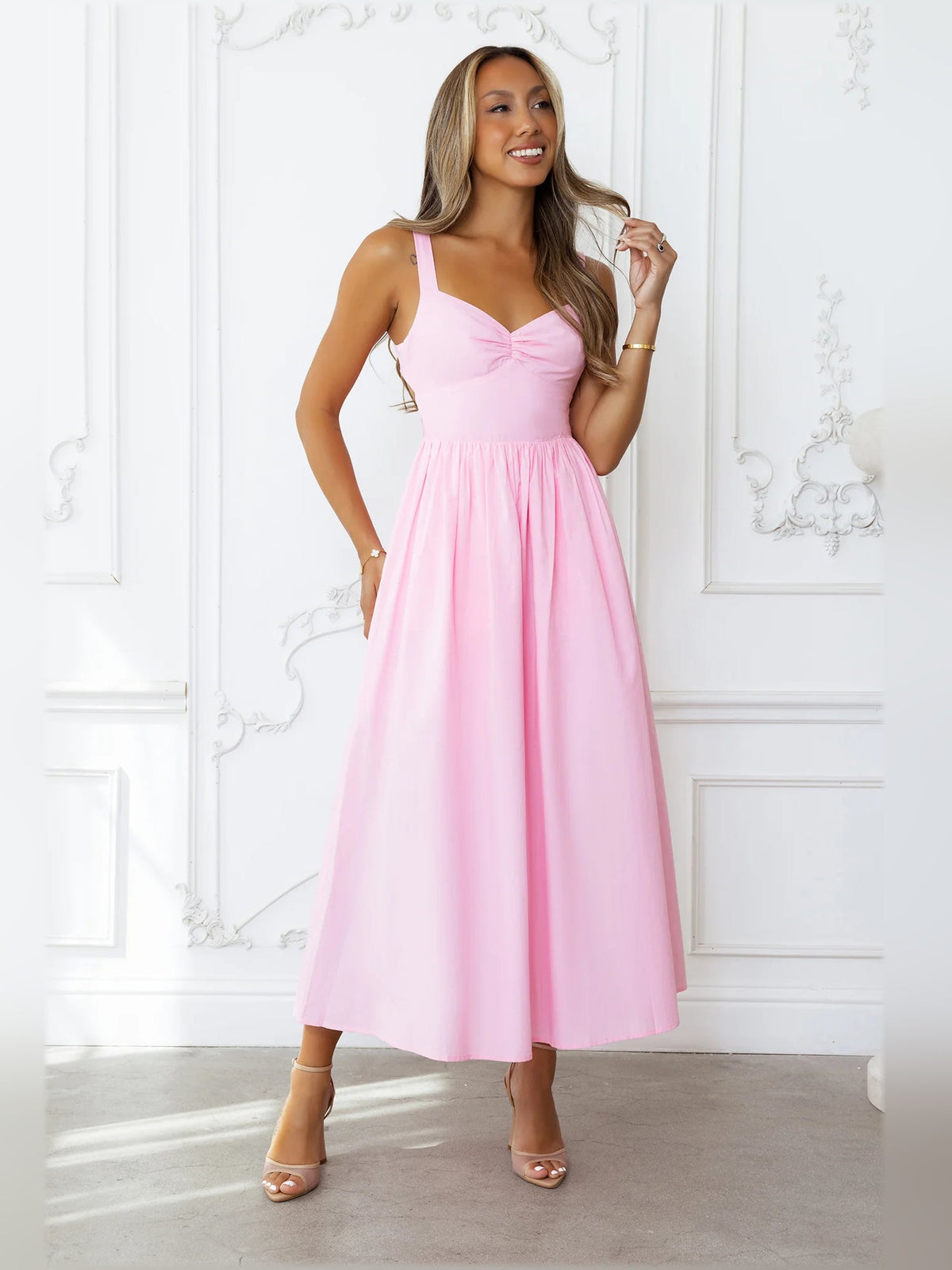 Pink midi formal dress with bow neckline, gathered waist, and sleeveless bodice
