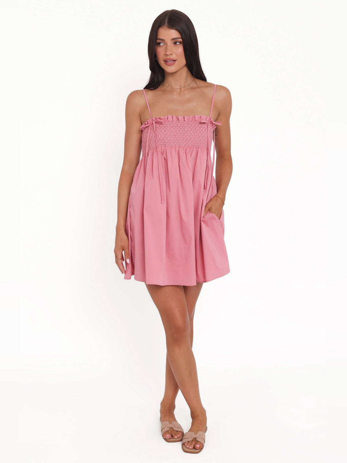 Pink mini homecoming dress with thin spaghetti straps, smocked bust, short babydoll skirt