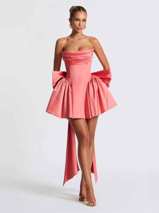 Pink strapless mini dress with fitted corset bodice, pleated flounce skirt, side ribbons
