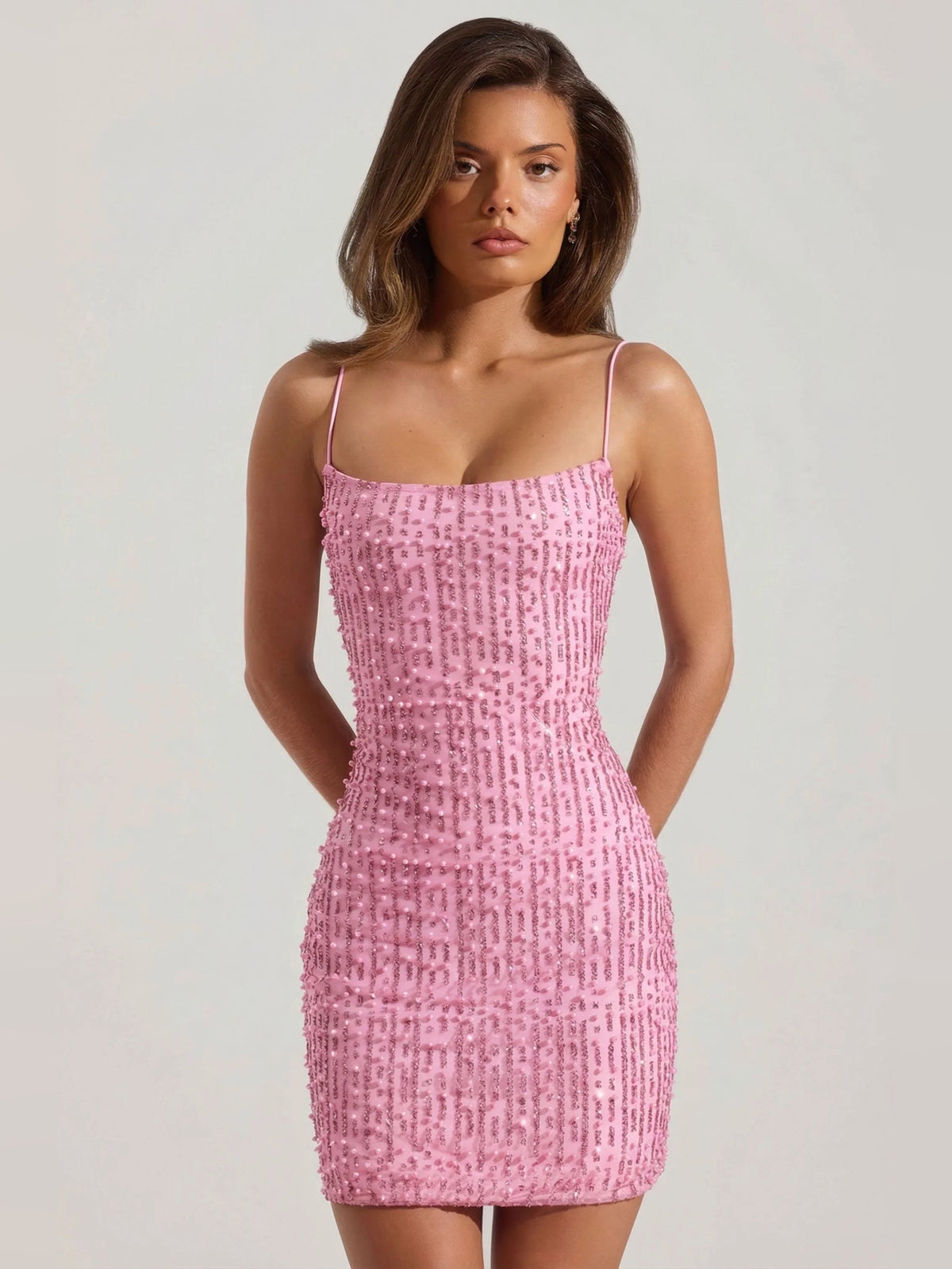 Pink scoop neck bodycon mini dress with spaghetti straps and all-over sequin texture