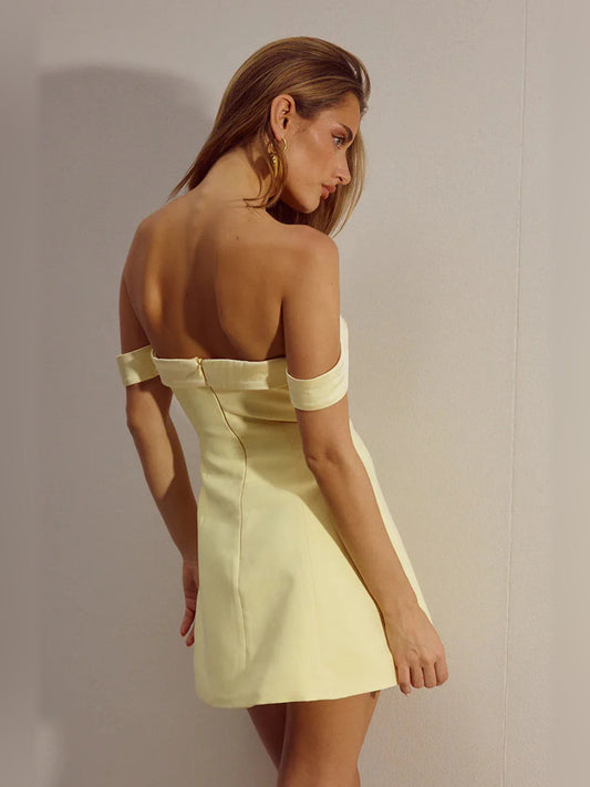 Pale yellow off-shoulder mini dress with sweetheart neckline and open-back design
