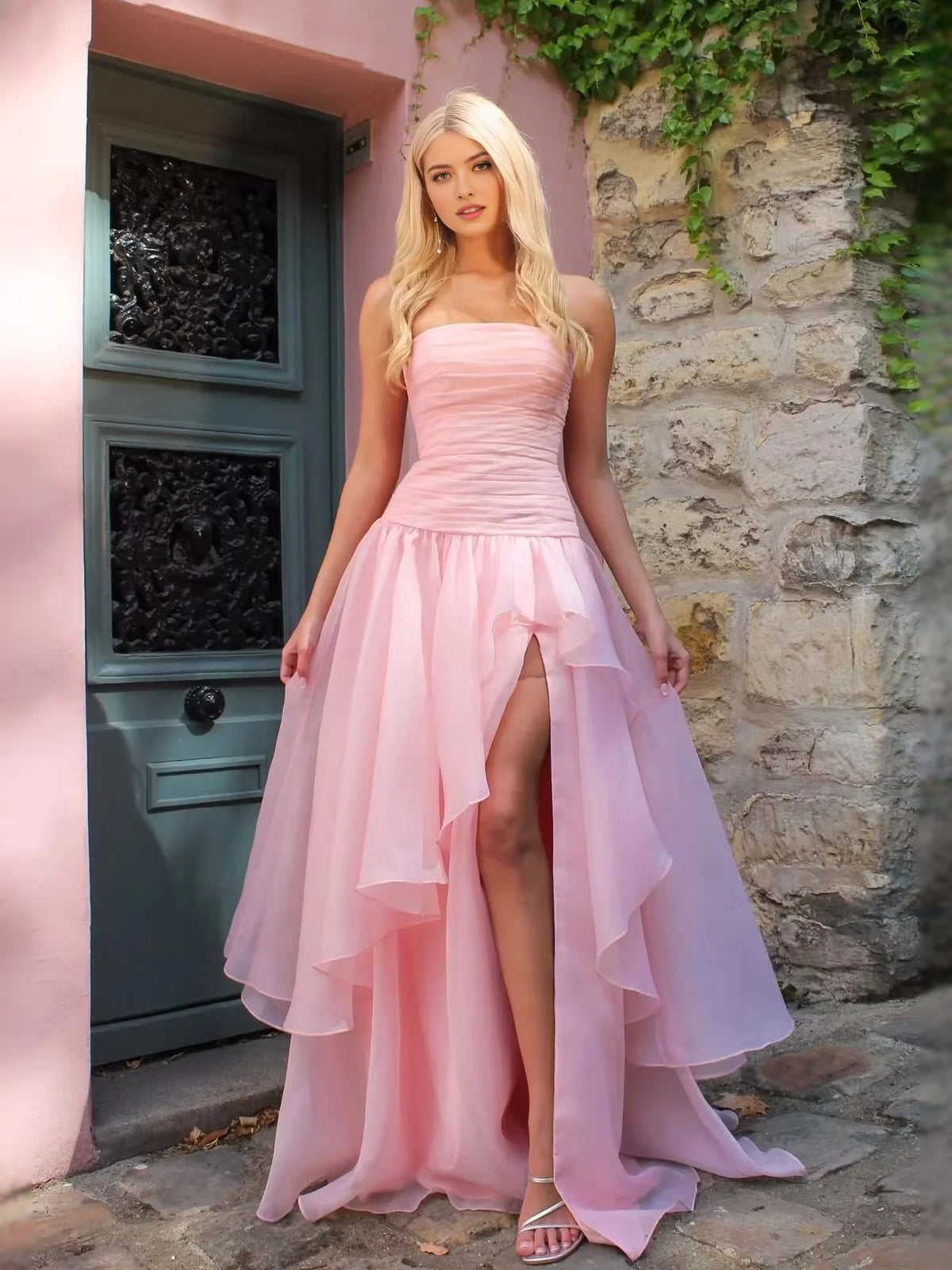 Soft blush pink strapless ruched prom dress with tiered skirt and front slit