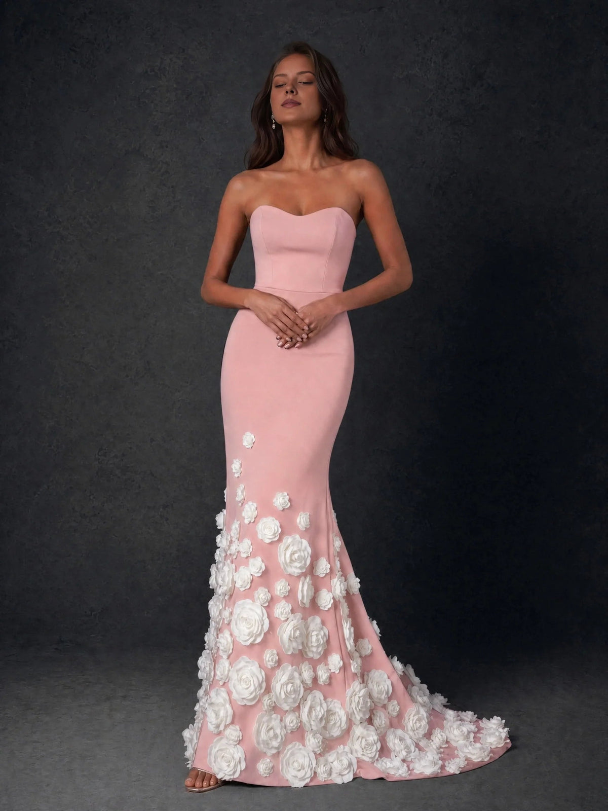 Blush pink sweetheart strapless formal gown with white rose floral appliques on skirt hem