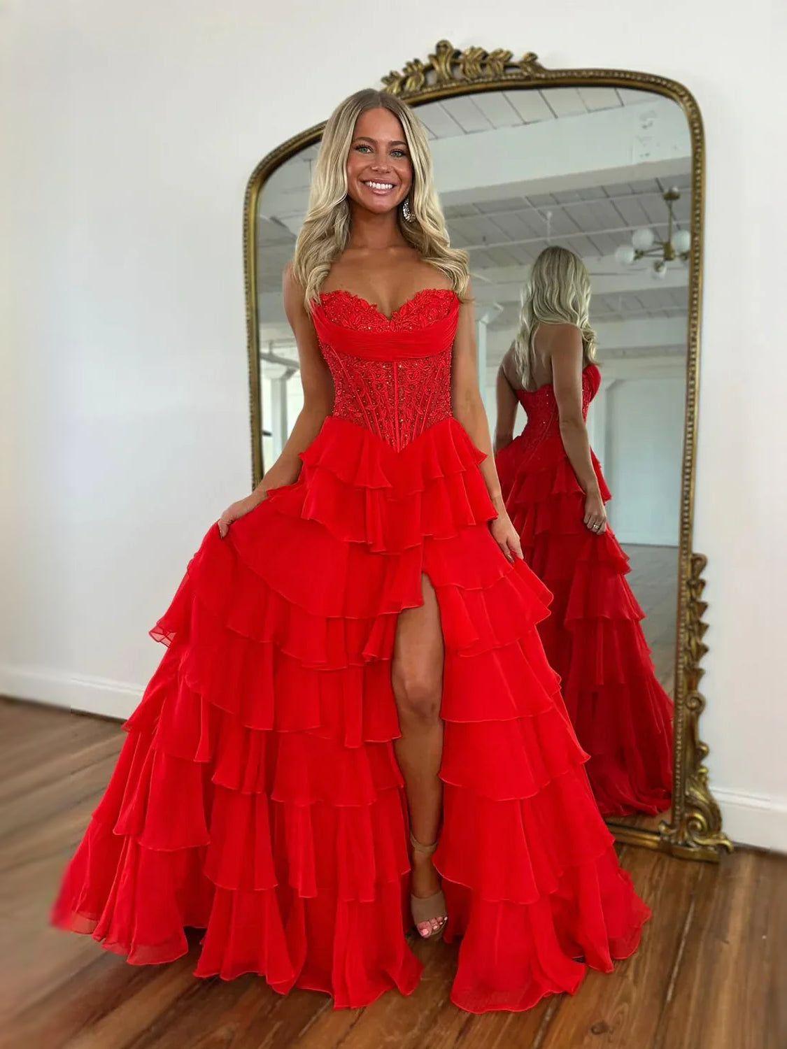 Red strapless corset prom dress with beaded bodice, layered tiered skirt and side slit