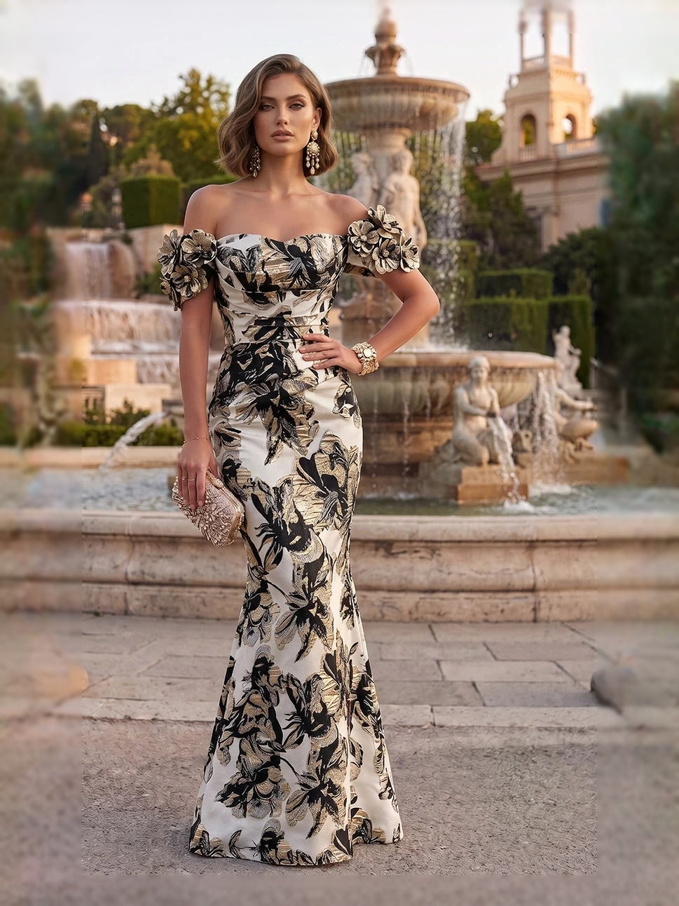 Black off-shoulder mermaid gown with ruched bodice and floral applique