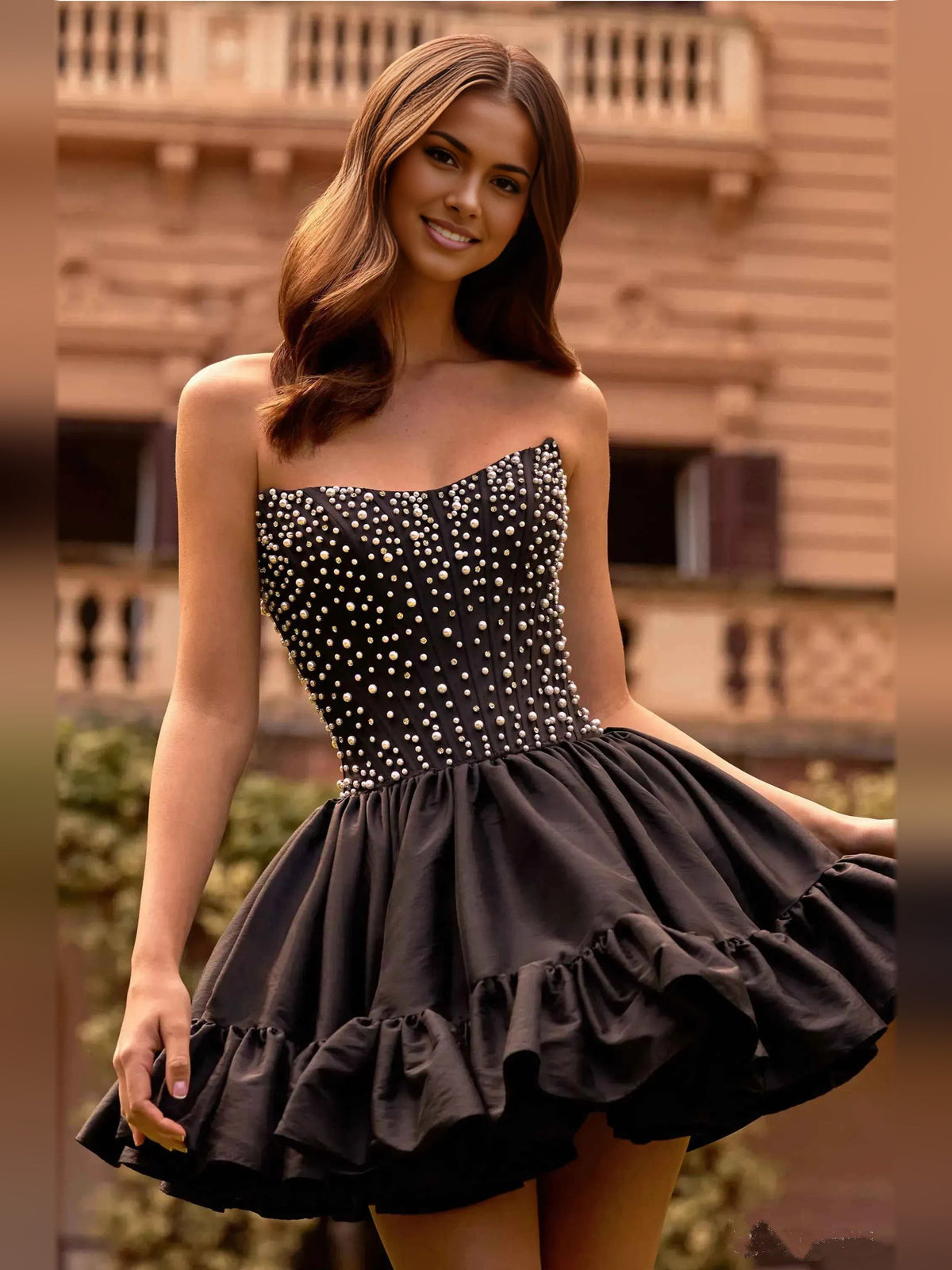 Black strapless corset mini dress with beaded dot bodice and layered ruffle skirt
