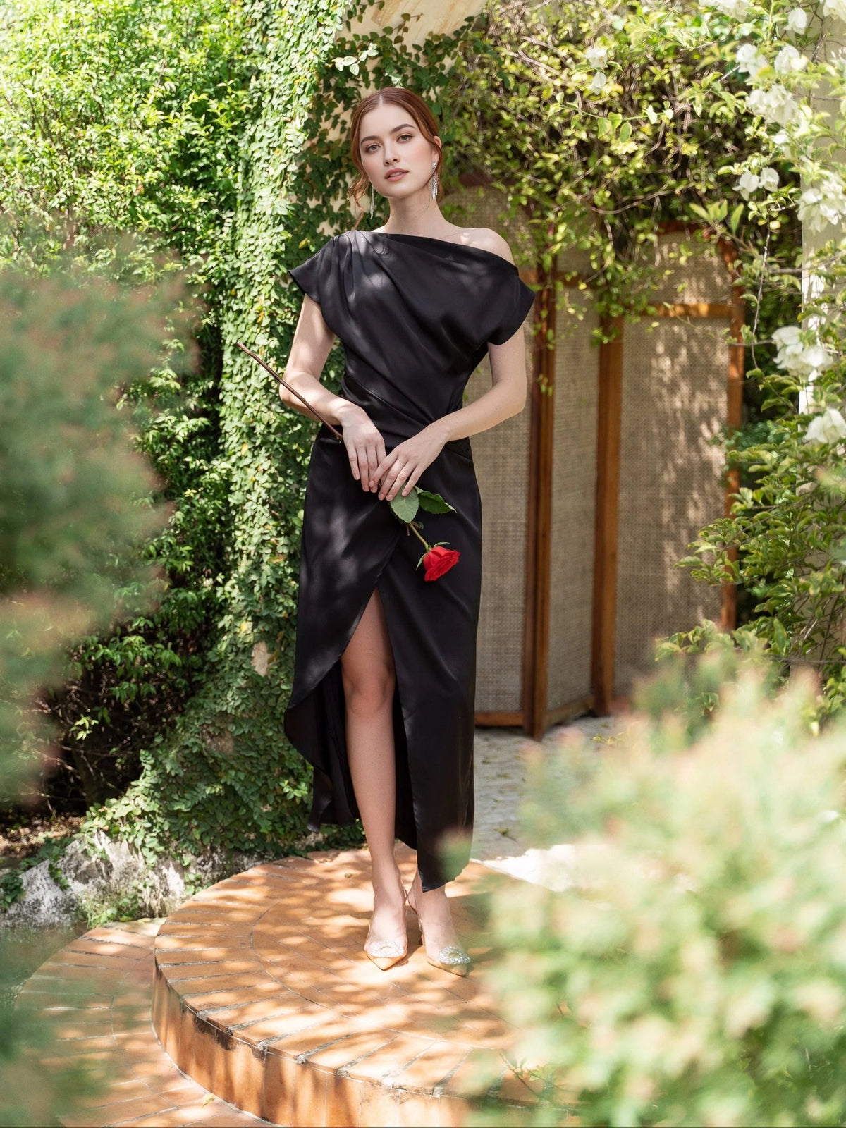 Black satin off-shoulder sheath prom dress with draped detail and front slit