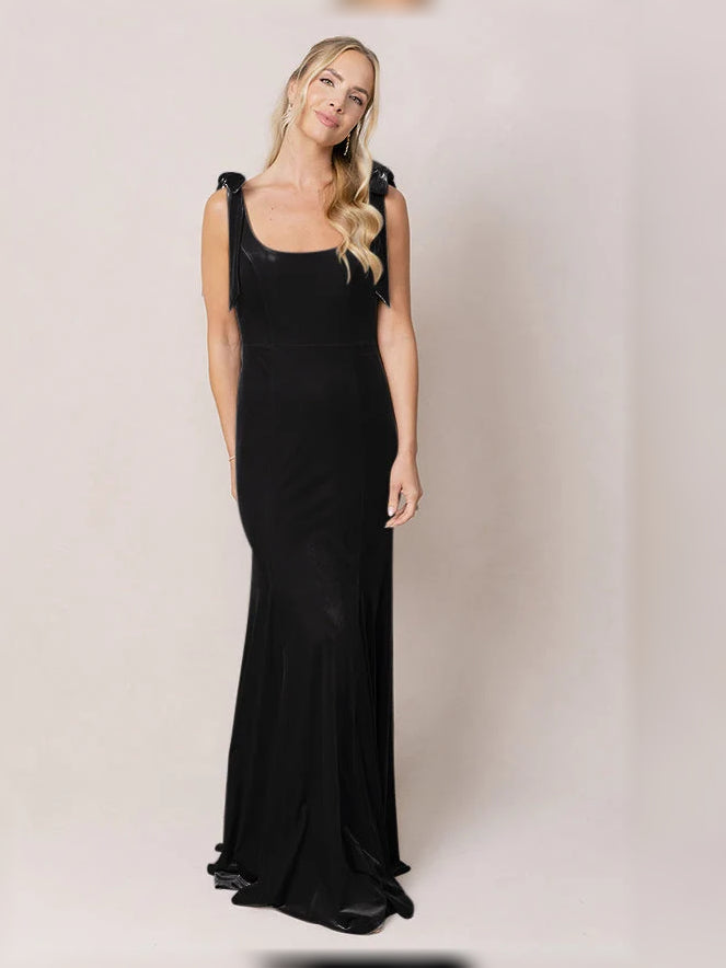 Black velvet mermaid dress with square neckline, fitted waist, floor-length hem.