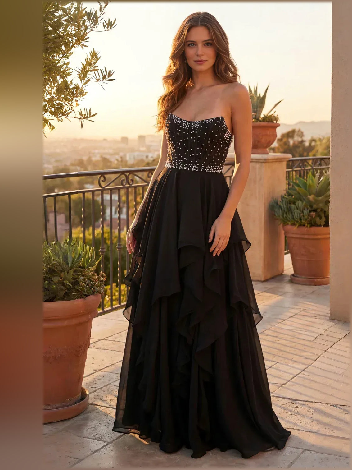 Full-length black strapless tiered ruffle dress with jeweled bodice
