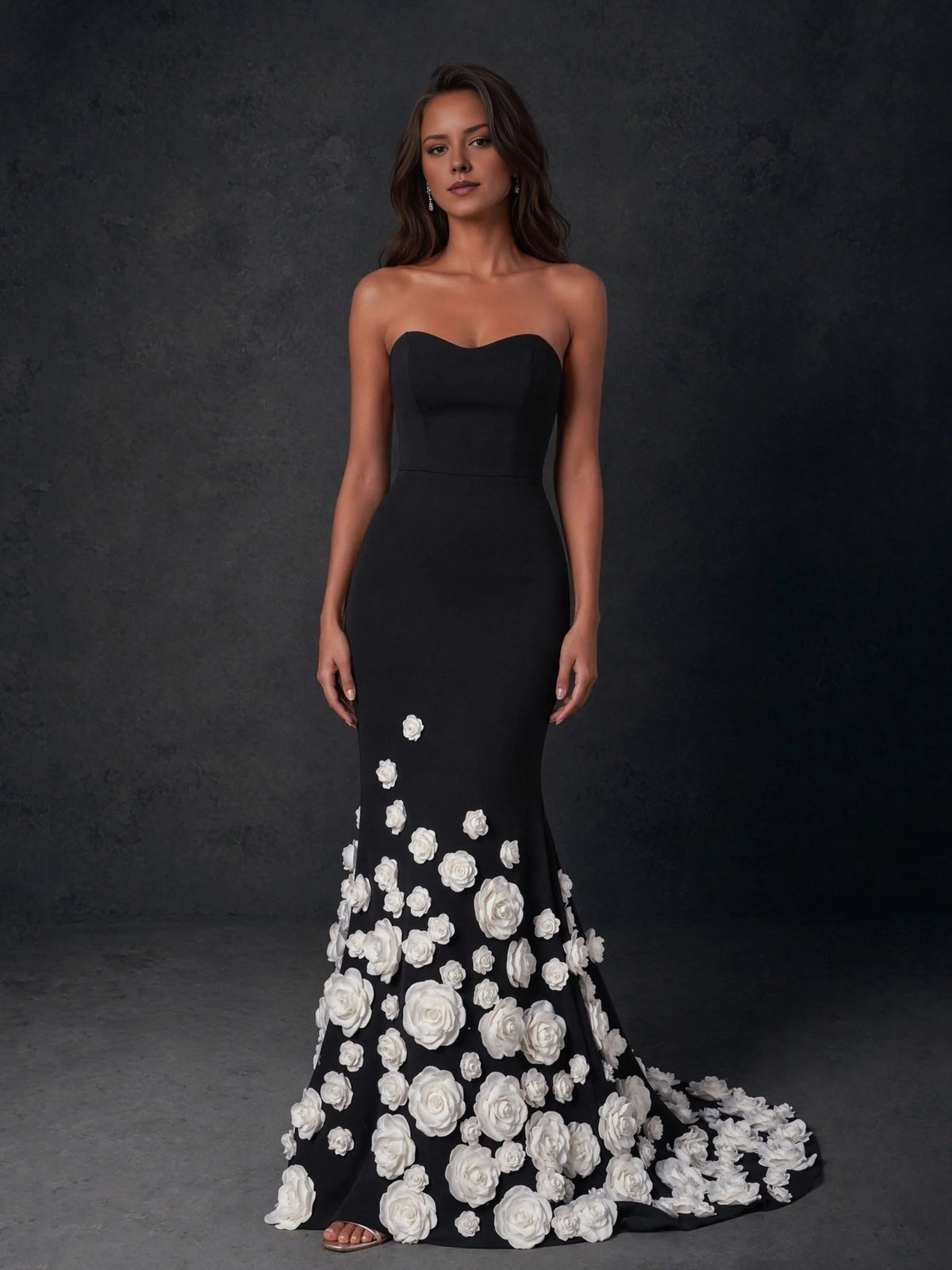 Black sweetheart strapless formal gown with white rose appliques and flowing mermaid skirt