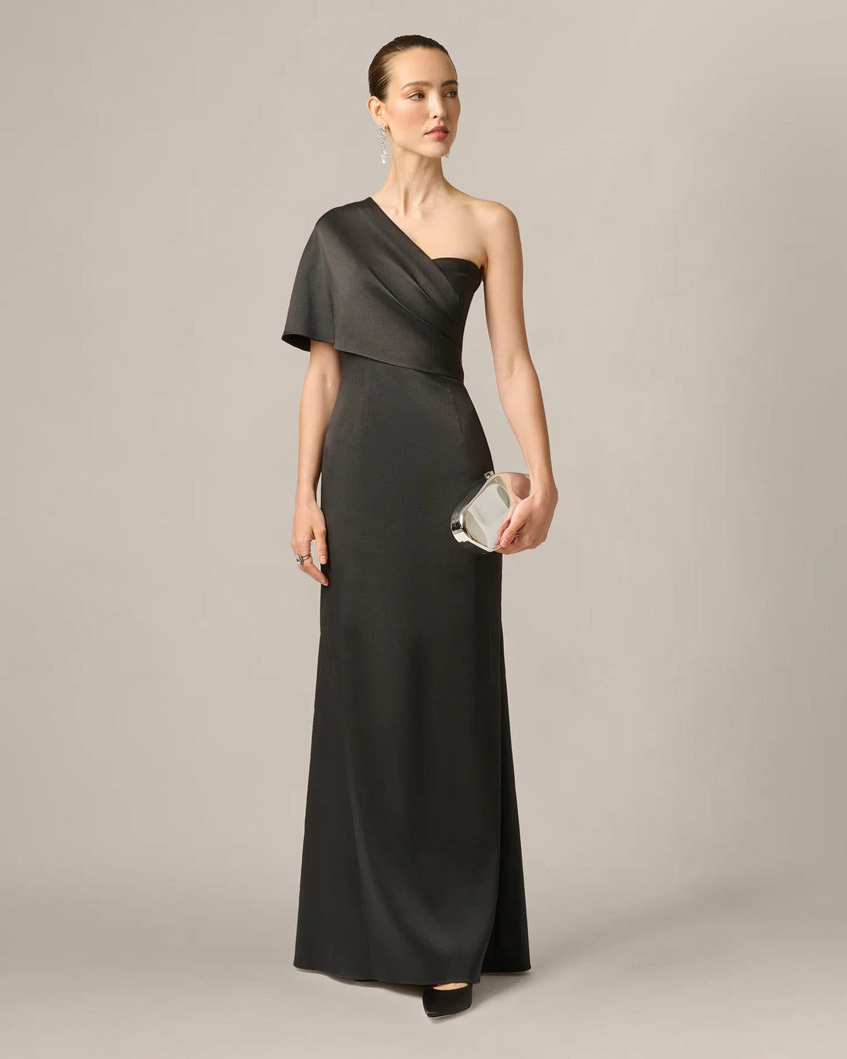 Black draped one-shoulder maxi dress with diagonal sash and mermaid hem