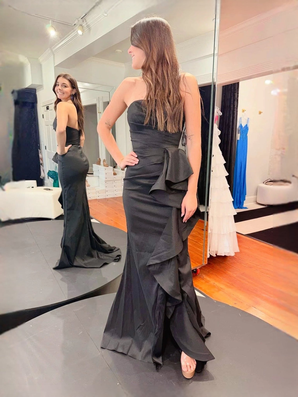 Black strapless mermaid prom dress with layered ruffle peplum, open back and slit
