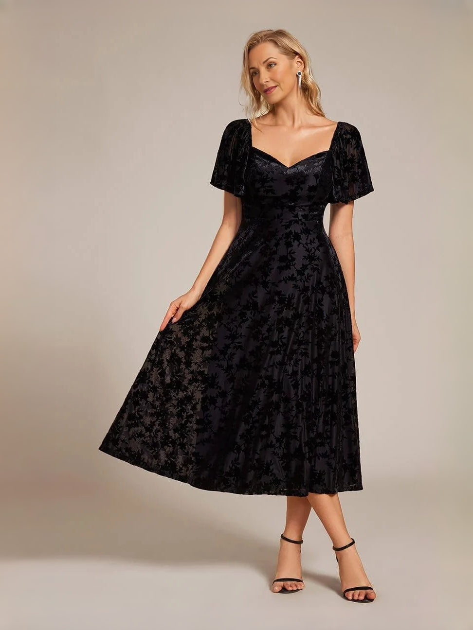 Black A-line midi dress with sweetheart neckline and short puff sleeves, front view