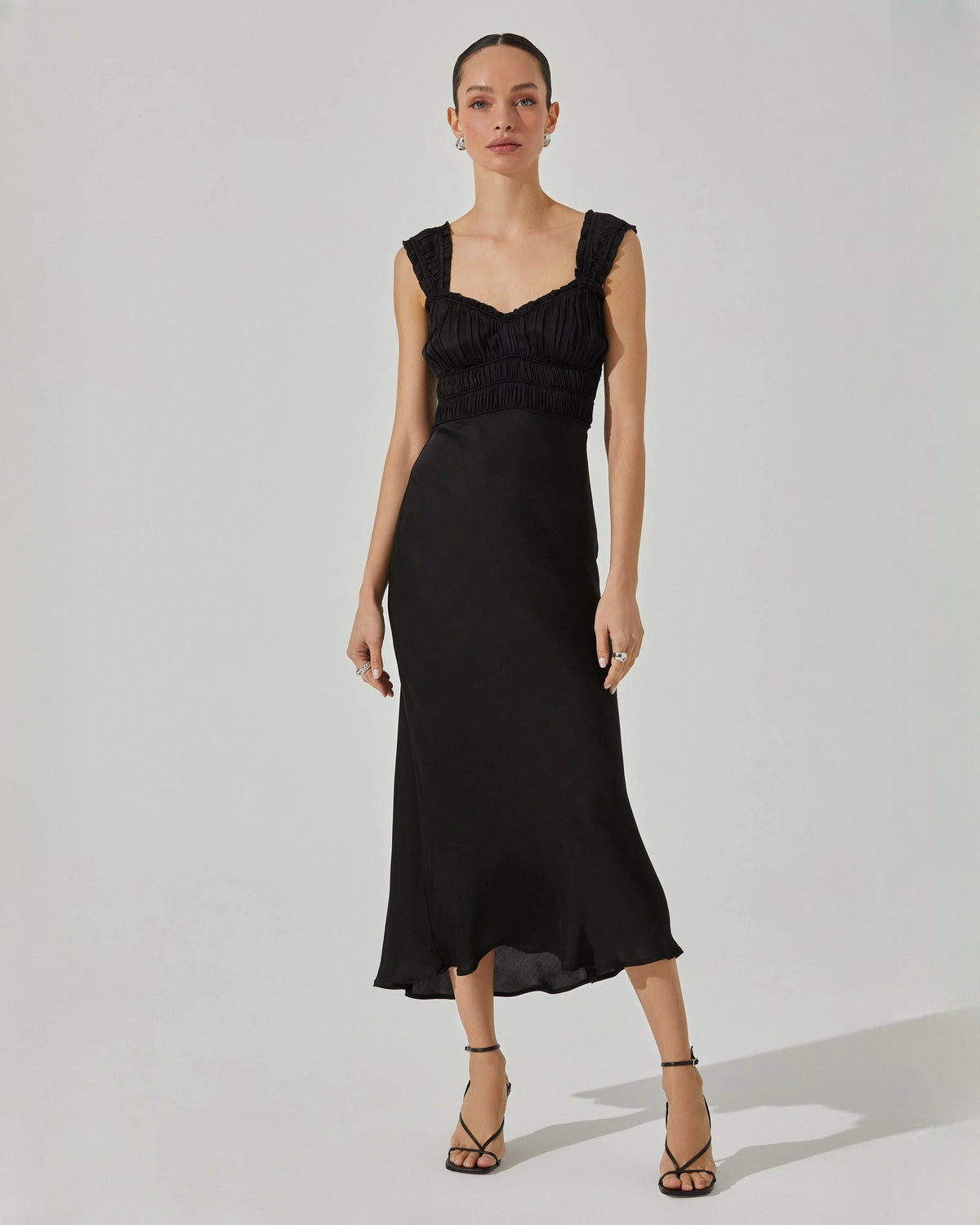 Black sleeveless midi dress with V-shaped neckline and ruched bust detail.