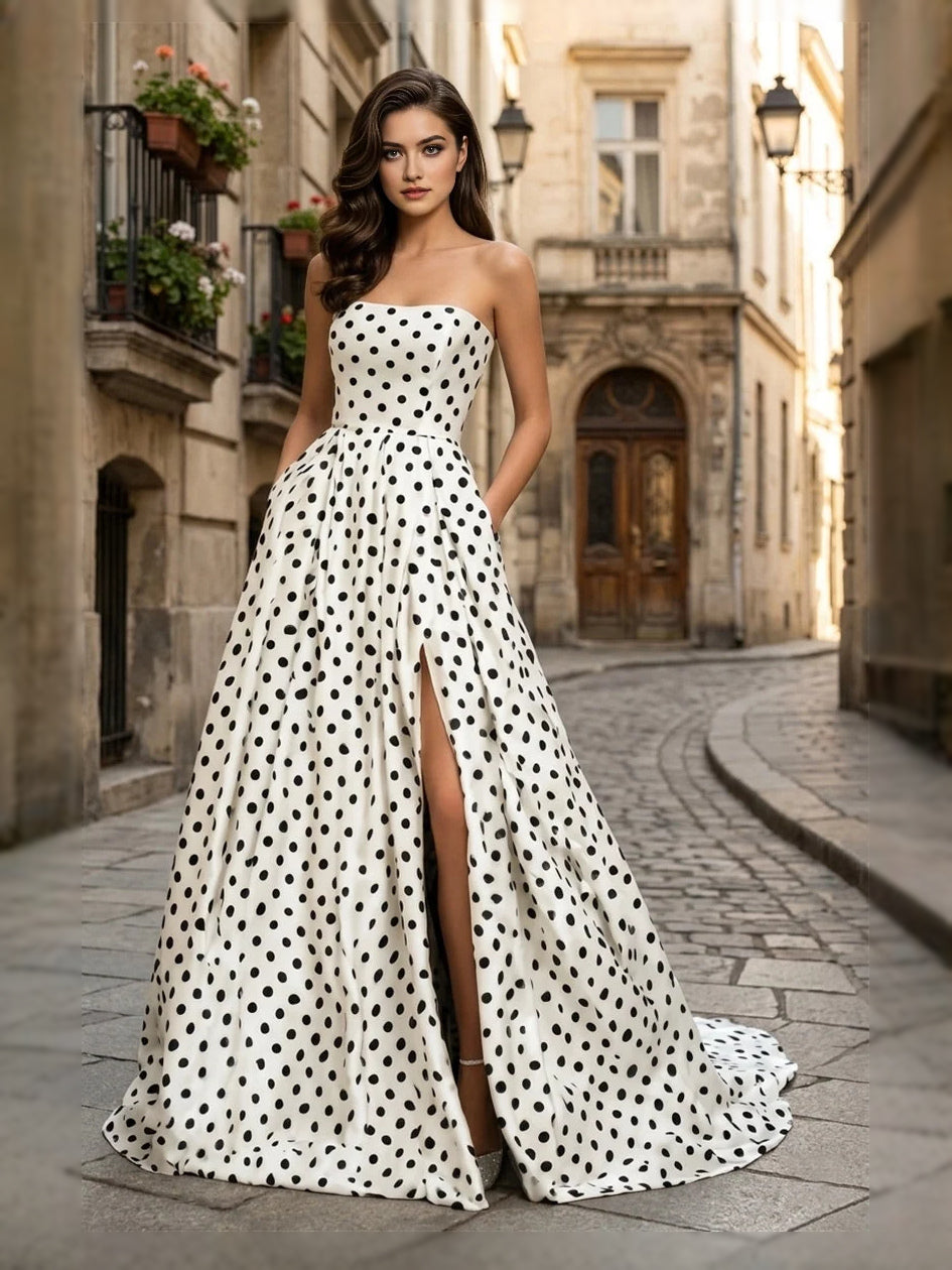 White strapless A-line prom dress with black polka dots and flowing full-length skirt